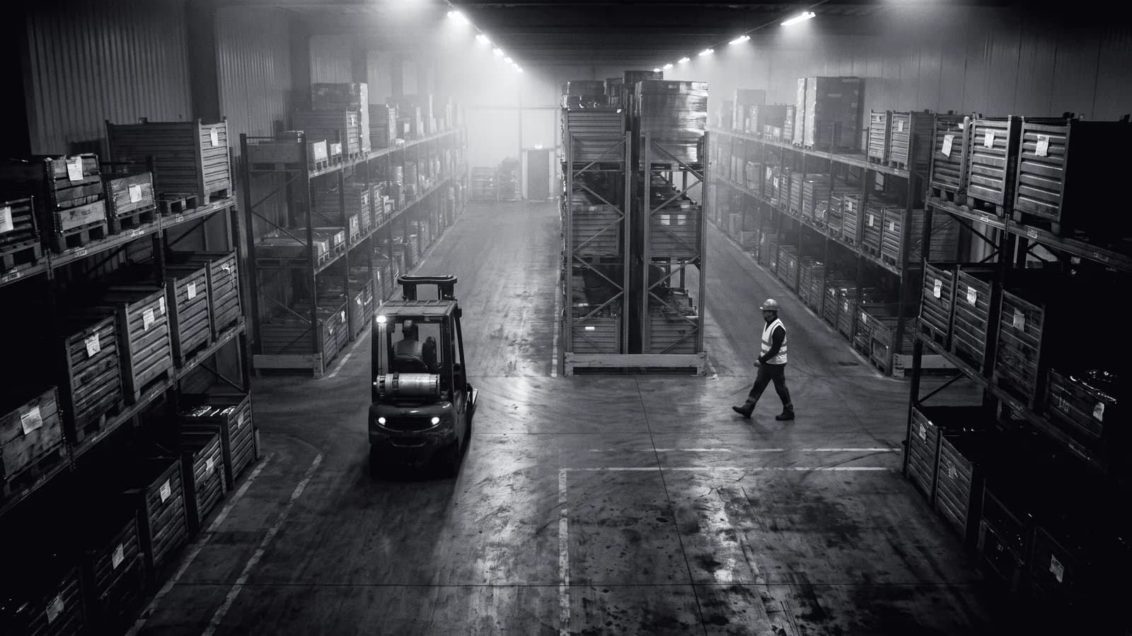 Illustrative frame: a warehouse aisle seen from above, with computer vision projecting the converging paths of a forklift and a pedestrian and the time to contact between them. Shown in black and white, with the annotated regions revealed in colour.